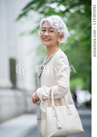 Stylish senior woman walking in the city Stylish senior woman walking in the city 114365092