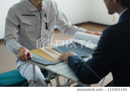 Men in suits and work clothes having a meeting Men in suits and work clothes having a meeting 114365184