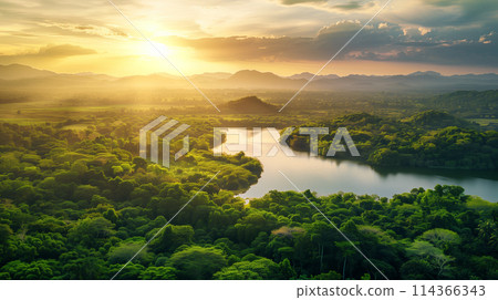 A beautiful landscape with a large body of water and a bright sun in the sky. The sun is setting, creating a warm and peaceful atmosphere 114366343