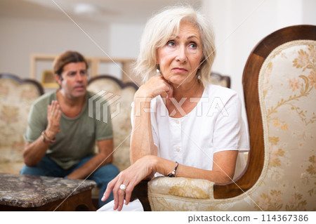Sad family having difficulties in living room at home 114367386