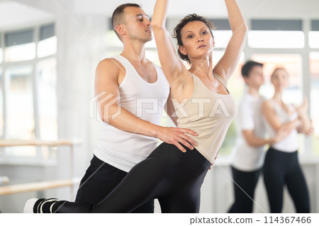 Young man and adult woman rehearsing pair ballet Young man and adult woman rehearsing pair ballet 114367466