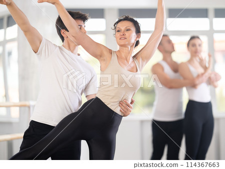 Young guy and adult woman rehearsing pair ballet Young guy and adult woman rehearsing pair ballet 114367663
