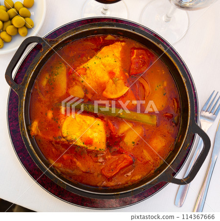 Baked merluse with vegetables and tomato sauce Baked merluse with vegetables and tomato sauce 114367666