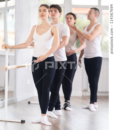 Woman participating group ballet class with male choreographer 114367694