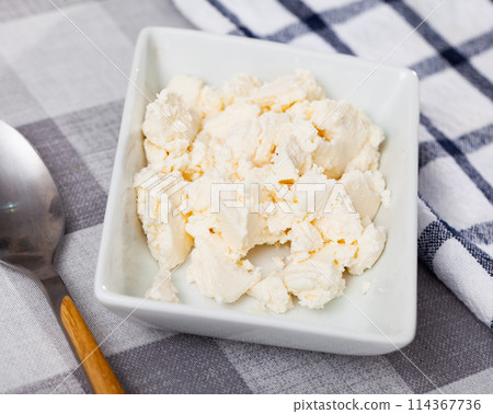 Young type of cheese on plate 114367736