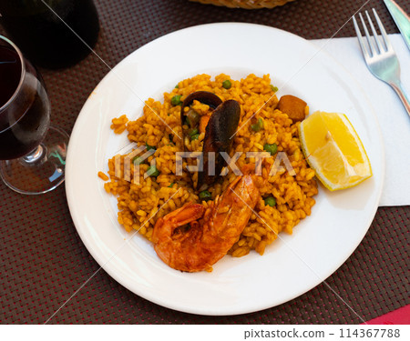 National dish of Spanish cuisine is Paella with seafood 114367788