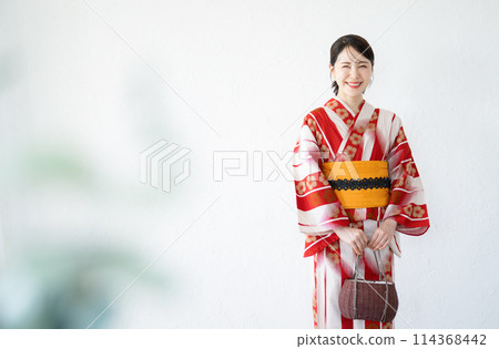 Upper body of a cute woman in a red yukata, white background, looking at the camera Upper body of a cute woman in a red yukata, white background, looking at the camera 114368442