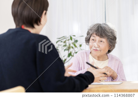 Senior women undergoing long-term care insurance certification survey 114368807