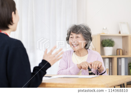 Senior women undergoing long-term care insurance certification survey 114368810