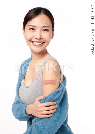 young asian women smiling after getting a vaccine, holding down her shirt sleeve and showing her arm with bandage after receiving vaccination on white background, young asian women smiling after getting a vaccine, holding down her shirt sleeve and showing her arm with bandage after receiving vaccination on white background, 114369104