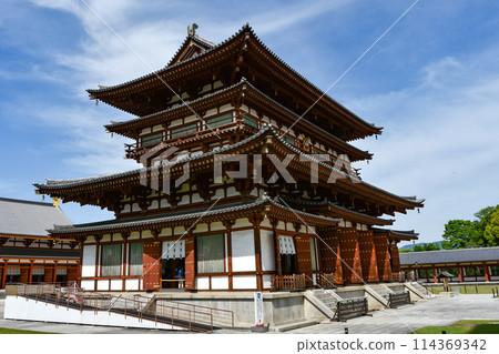 Yakushiji temple's main hall shines against the blue sky Yakushiji temple's main hall shines against the blue sky 114369342