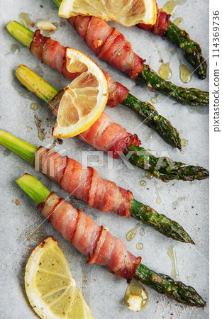 Asparagus baked with bacon 114369736