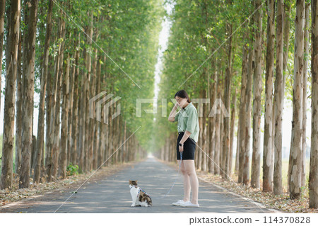 asian woman happy during travel and play with her cat on spring season asian woman happy during travel and play with her cat on spring season 114370828
