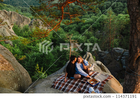 happy couple having date at the cliff on sunset 114371191