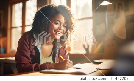 A happy young dark-skinned, black, African-American girl rejoices at a letter from an educational institution about admission. A happy young dark-skinned, black, African-American girl rejoices at a letter from an educational institution about admission. 114372051