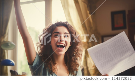 A happy young girl rejoices at a letter from an educational institution about admission. A happy young girl rejoices at a letter from an educational institution about admission. 114372052