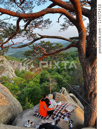 happy couple having date at the cliff on sunset 114372418