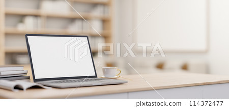 A laptop computer mockup on a minimal wooden table in a contemporary luxurious home office. 114372477