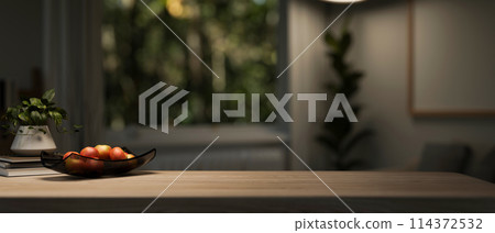 A copy space for displaying products on a wooden tabletop in a dark living room with a dim light. A copy space for displaying products on a wooden tabletop in a dark living room with a dim light. 114372532
