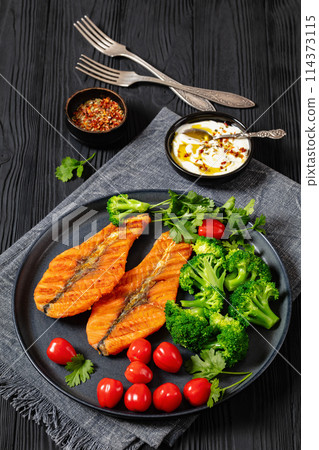 grilled salmon steaks with broccoli and tomatoes grilled salmon steaks with broccoli and tomatoes 114373115