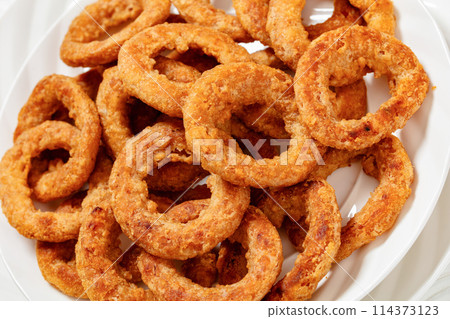 deep fried crispy onion rings on white plate deep fried crispy onion rings on white plate 114373123