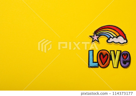 LGBT parade concept, free love symbol on yellow background. LGBT parade concept, free love symbol on yellow background. 114373177