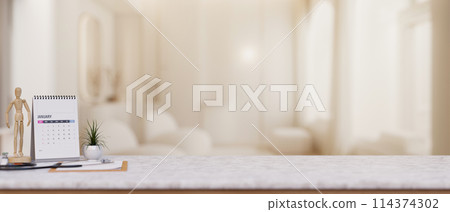 A doctor's office desk features a space on the white marble desk in a modern luxurious clinic lounge A doctor's office desk features a space on the white marble desk in a modern luxurious clinic lounge 114374302