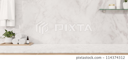 A modern luxurious white marble bathroom tabletop features a toiletry set, towels, and a space. 114374312