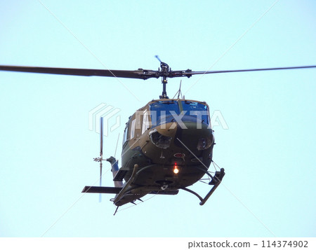 Japan Ground Self-Defense Force UH-1J helicopter flying during a training demonstration 114374902
