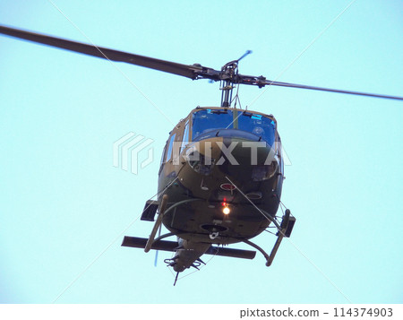 Japan Ground Self-Defense Force UH-1J helicopter flying during a training demonstration Japan Ground Self-Defense Force UH-1J helicopter flying during a training demonstration 114374903
