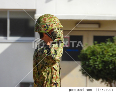 A member of the Ground Self-Defense Forces in camouflage uniform saluting A member of the Ground Self-Defense Forces in camouflage uniform saluting 114374904