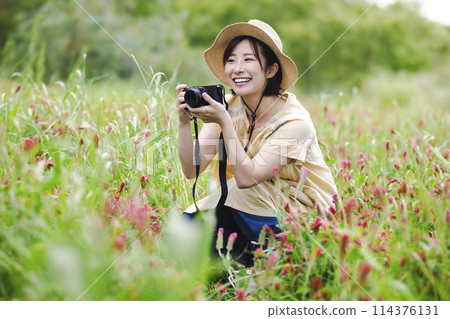 Woman with a camera in a flower field Woman with a camera in a flower field 114376131