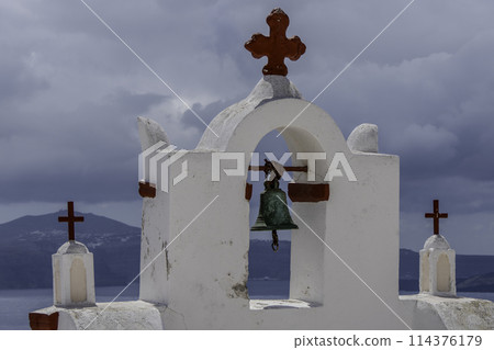 Greece, Santorini, Oia, Traditional white bell tower of church with red crosses 114376179