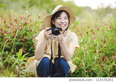 Woman with a camera in a flower field Woman with a camera in a flower field 114376261