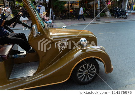 Cars driving through Hoi An, Vietnam 114376976