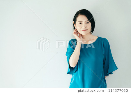 A woman smiling at the camera A woman smiling at the camera 114377030