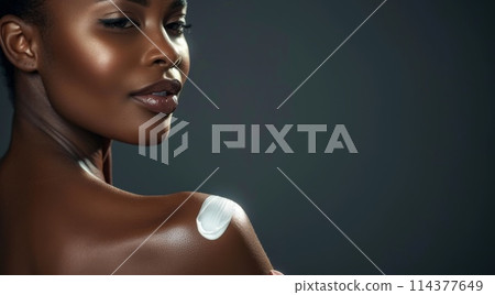 Elegant African Woman with Moisturizer on Shoulder in Close-Up Portrait Elegant African Woman with Moisturizer on Shoulder in Close-Up Portrait 114377649