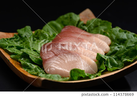 Close up of fresh raw Hamachi sashimi on black plate. Japanese food style Close up of fresh raw Hamachi sashimi on black plate. Japanese food style 114378669
