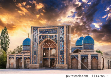ancient Muslim Madrasah of Barak Khan at sunset in summer. Hazrati Imam Architectural Complex in Tashkent in Uzbekistan ancient Muslim Madrasah of Barak Khan at sunset in summer. Hazrati Imam Architectural Complex in Tashkent in Uzbekistan 114378898