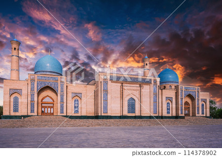ancient medieval Muslim Islamic mosque Hazrati Imam in Tashkent in Uzbekistan on background of a sunset sky 114378902