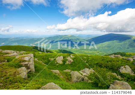 scenery of polonyna smooth. mountainous landscape of ukraine in summer. stones on the grassy hillside in dappled light beneath a blue sky with clouds. travel destination of carpathian mountains 114379046
