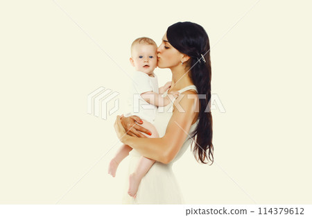 Happy young mother kissing baby on white studio background 114379612