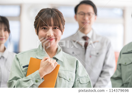 Three male and female engineers in work clothes 114379696