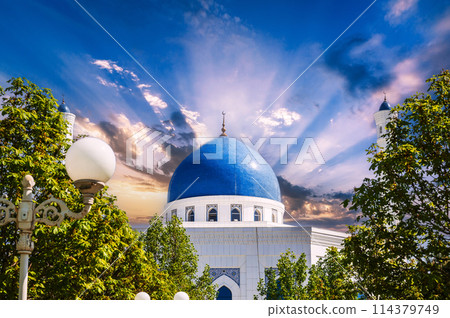 blue dome of modern white marble Islamic Masjid Minor Mosque in Tashkent in Uzbekistan on background of the sunset sky in summer blue dome of modern white marble Islamic Masjid Minor Mosque in Tashkent in Uzbekistan on background of the sunset sky in summer 114379749