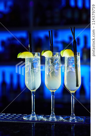 Alcoholic cocktails decorated with lime slices on the bar Alcoholic cocktails decorated with lime slices on the bar 114379759