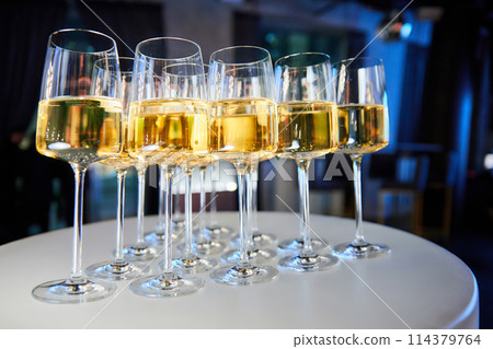 Set of glasses with white wine on a buffet table 114379764