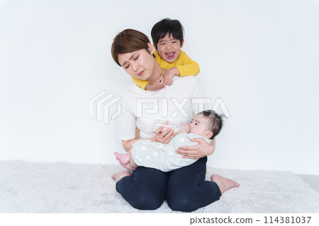 Stressed mother with baby and childcare 114381037