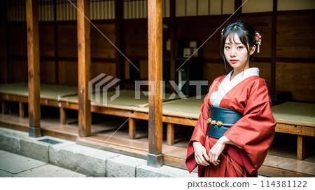 A woman in a kimono standing with an old Japanese townscape in the background 114381122