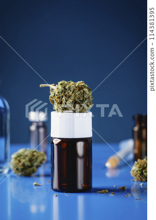 cannabis bud on top of a flask cannabis bud on top of a flask 114381395