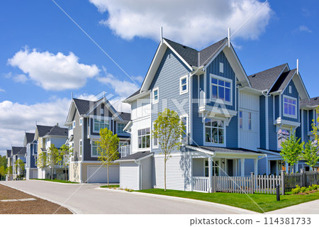 A perfect neighborhood. Brand new townhouses district on blue sky background 114381733